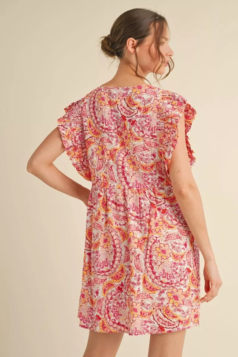 Woman wearing a floral dress on a beige background