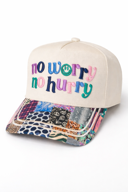 Cap with 'no worry no hurry' text on a white background
