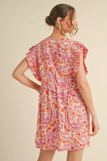Woman wearing a floral dress on a beige background