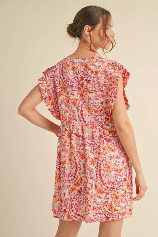 Woman wearing a floral dress on a beige background
