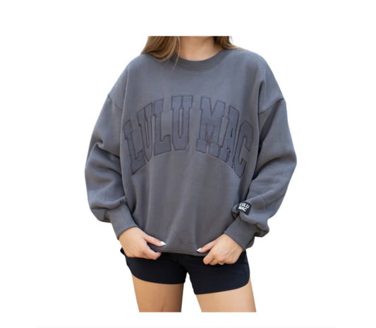 Person wearing a gray sweatshirt with 'Lululemon' branding on a white background