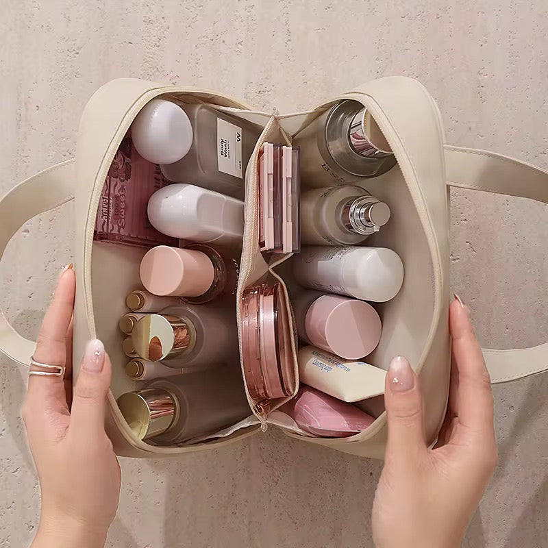 Beige toiletry bag with various skincare products on a neutral background