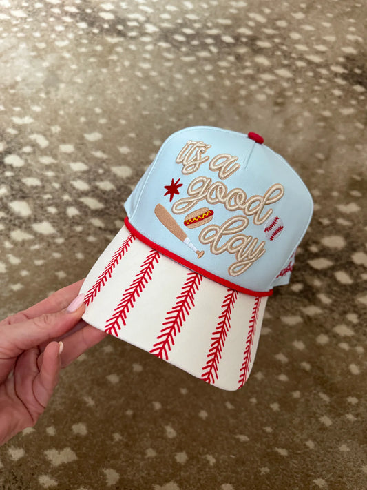 Hand holding a small ice cream cone-shaped container with 'It's a good day' text on a textured surface.